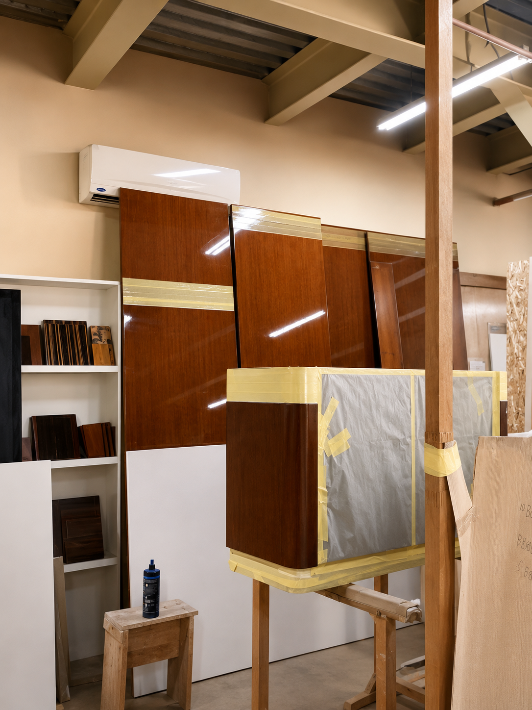 Panels masked and staged ahead of spray finishing — protecting edges before lacquering
